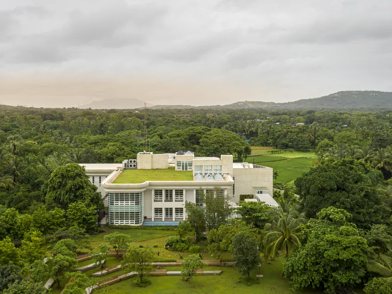 AliGunjan surrounded by trees and the hills of Alibaug.